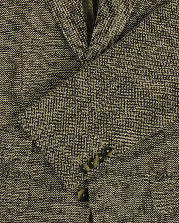 Close-up of the Single-Breasted Yarn Dyed Linen Suit Jacket sleeve with four brown buttons and herringbone texture.