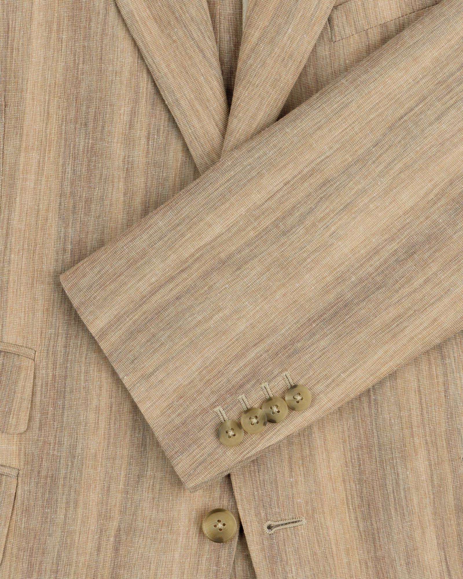 Close-up of a Single-Breasted Safari Suit Jacket sleeve in beige with four brown buttons and part of the pocket visible.