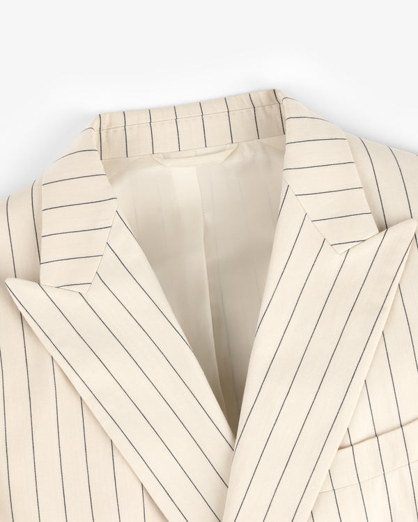 Close-up of a Double-Breasted Pinstripe Suit Jacket in cream with navy blue vertical stripes and wide lapels.