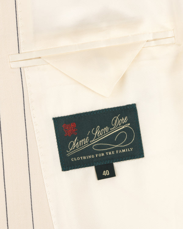 Aimé Leon Dore Double-Breasted Pinstripe Suit Jacket label, size 40, on cream fabric with a pocket.