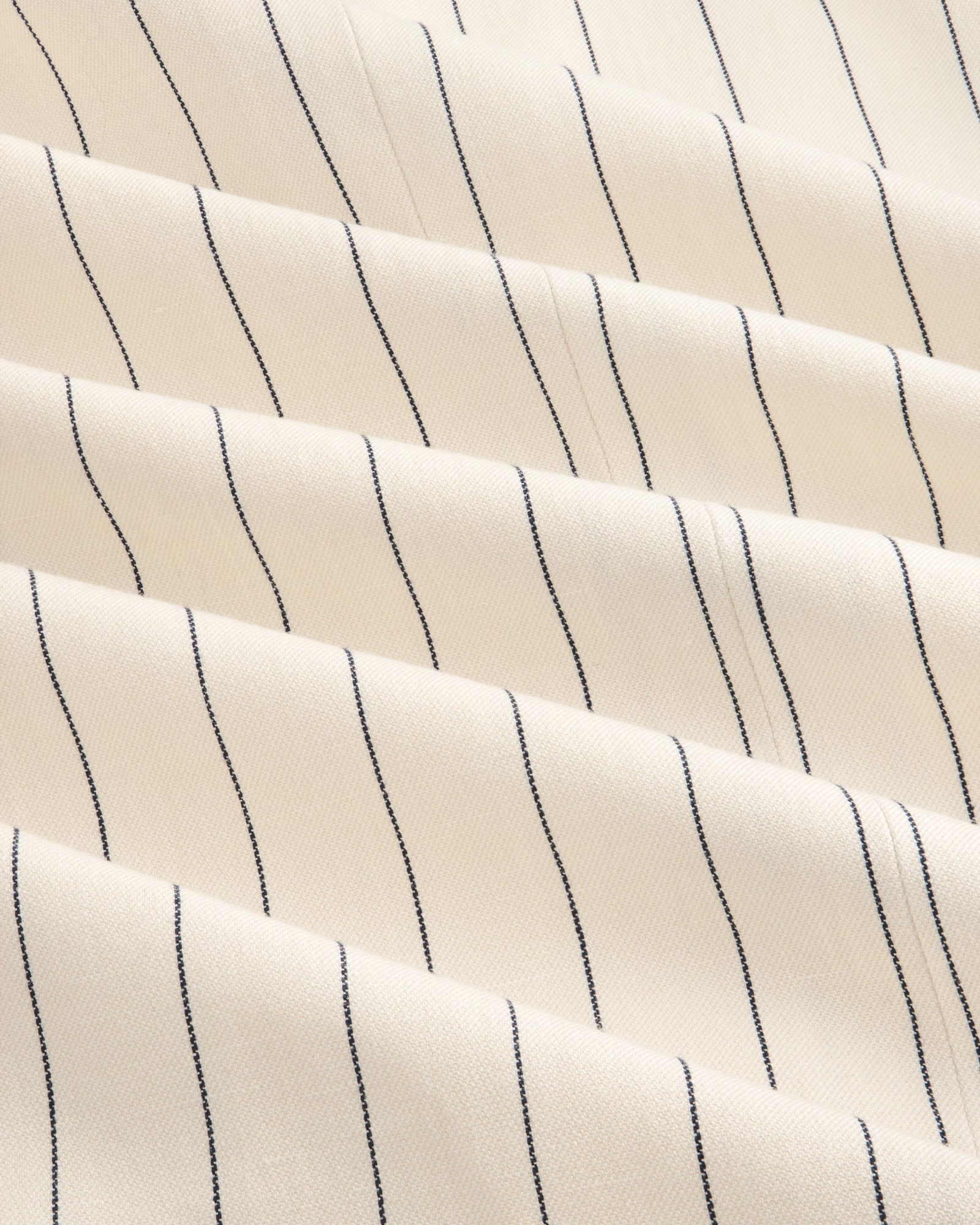 Cream-colored Double-Breasted Pinstripe Suit Jacket with thin black stripes and a subtly textured surface.
