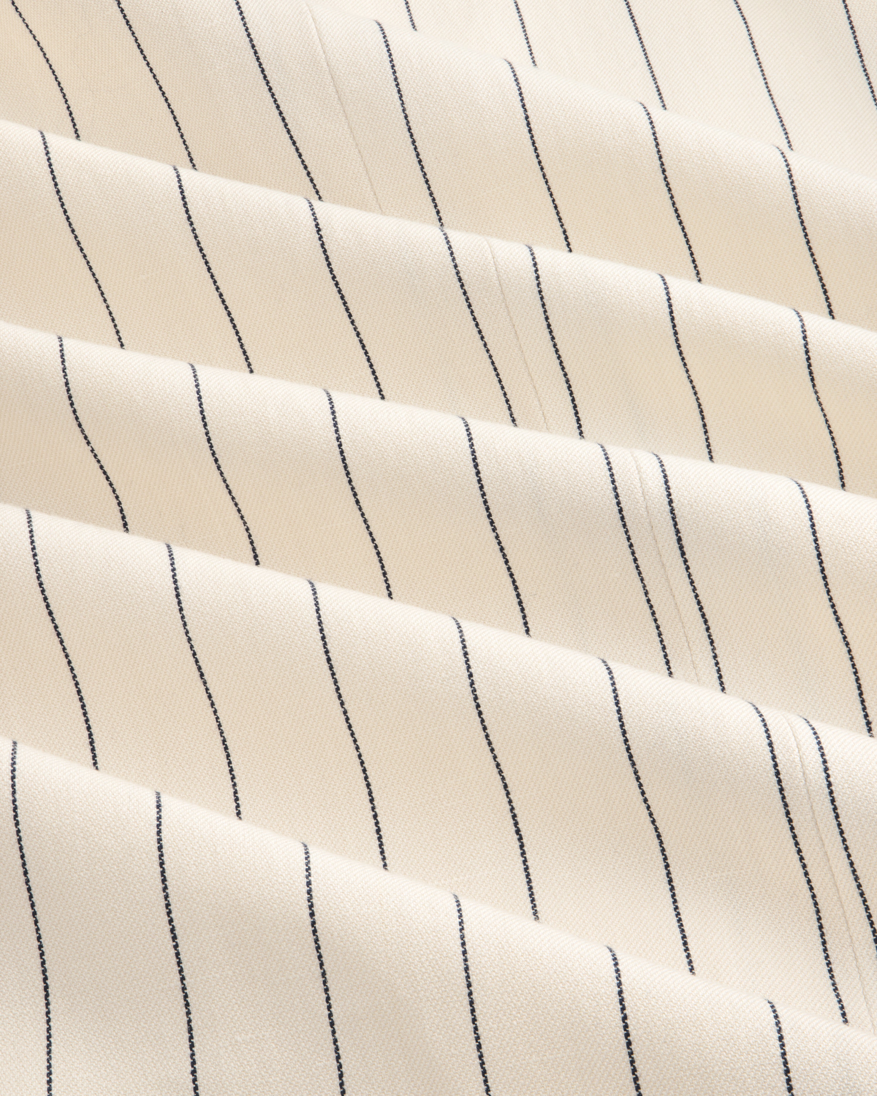Cream-colored Double-Breasted Pinstripe Suit Jacket with thin black stripes and a subtly textured surface.