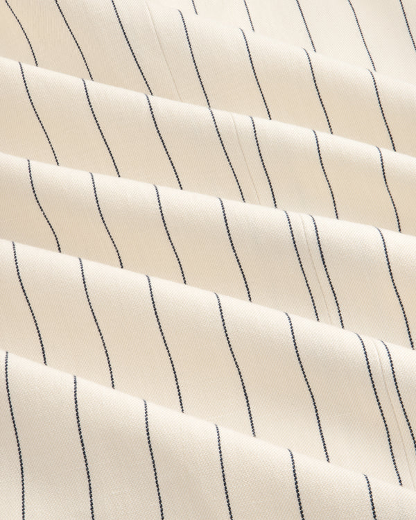 Cream-colored Double-Breasted Pinstripe Suit Jacket with thin black stripes and a subtly textured surface.