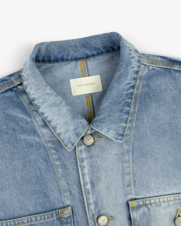 Denim Trucker Jacket in light blue with collar, button closure, and visible stitching on a white background.