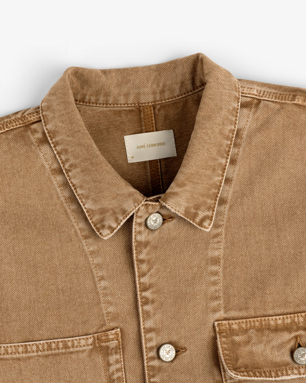 Light brown Denim Trucker Jacket with collar, button closure, and two chest pockets on a white surface.