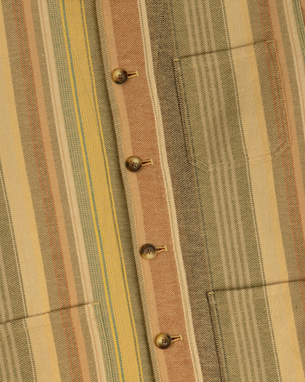 Close-up of the Blanket Striped Chore Jacket with brown buttons, front pocket, and yellow, green, and tan stripes.