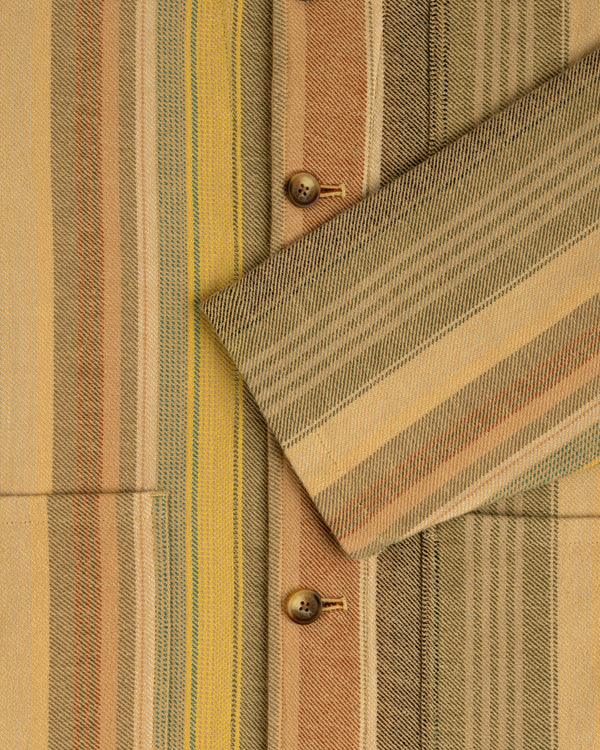 Close-up of the Blanket Striped Chore Jacket featuring multicolored stripes, wooden buttons, and a crossed-over sleeve.