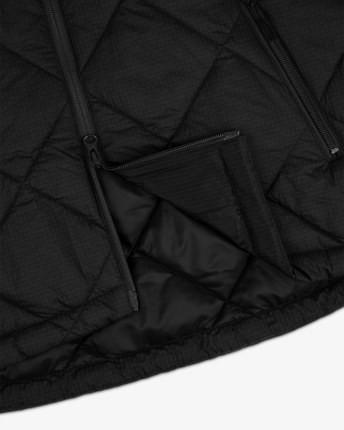 Close-up of the Nylon Quilted Unisphere Jacket with zippers and a partially opened zippered pocket.