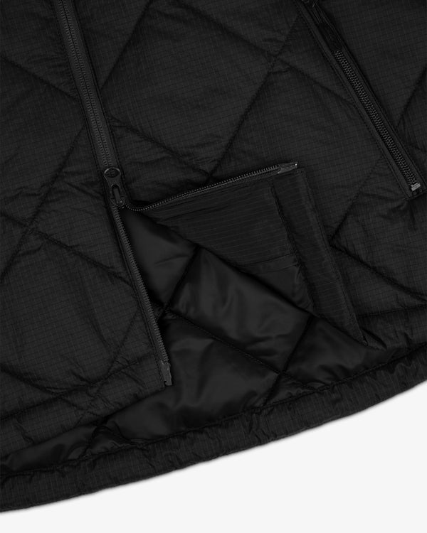 Close-up of the Nylon Quilted Unisphere Jacket with zippers and a partially opened zippered pocket.
