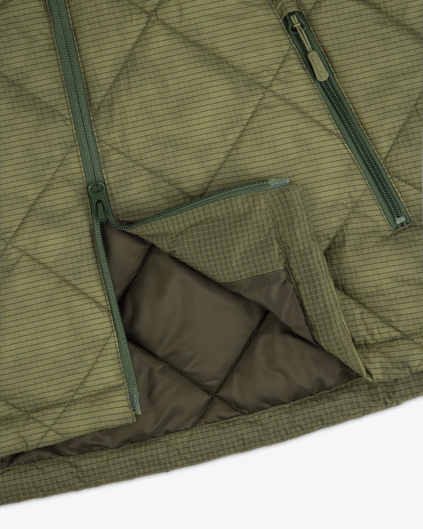 Close-up of the Nylon Quilted Unisphere Jacket in olive green with diagonal zippers and grid stitching.