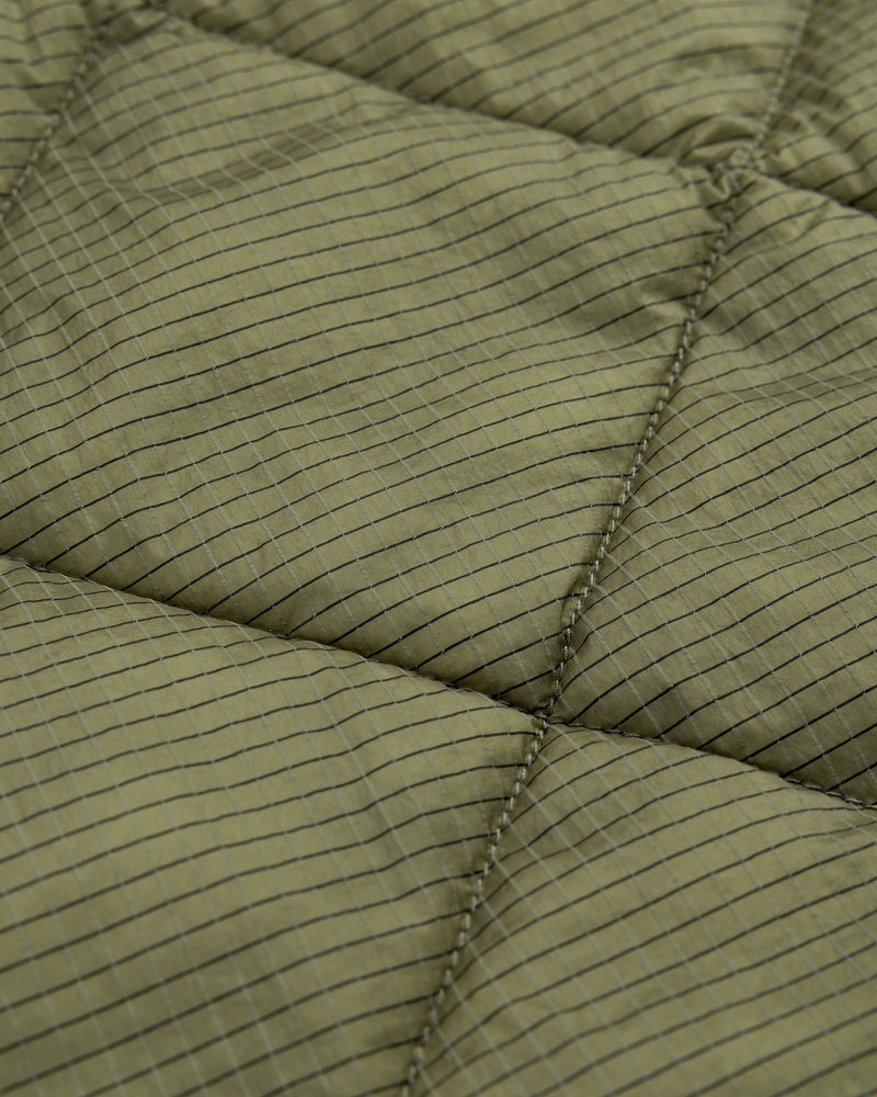 Close-up of Nylon Quilted Unisphere Jacket in olive green with square grid and visible stitching.