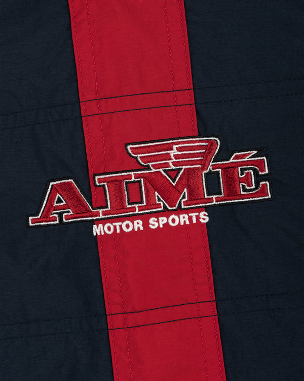 Nylon Moto Jacket in red and navy with AIMÉ MOTOR SPORTS logo and wing design above the letter M.
