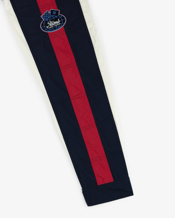 Nylon Moto Jacket with red and navy blue stripes and a round crown patch with "Ninety" text.