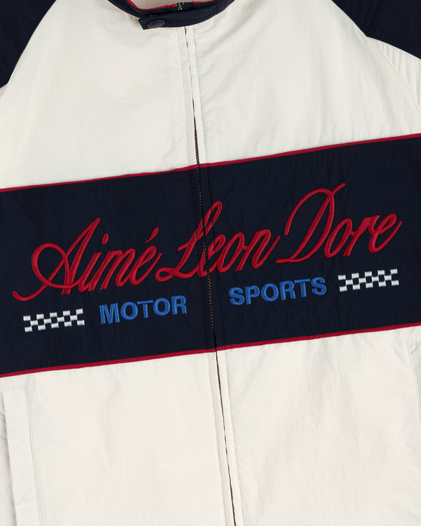 Close-up of the Nylon Moto Jacket with Aimé Leon Dore MOTOR SPORTS and checkered patterns embroidered on the front.