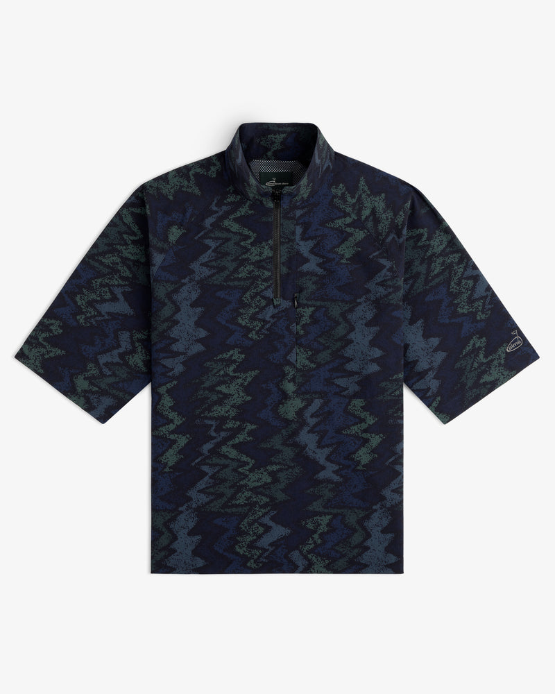 ALD Golf Nylon Quarter Zip Pullover in dark blue and green zigzag pattern, short-sleeve, flat on white background.
