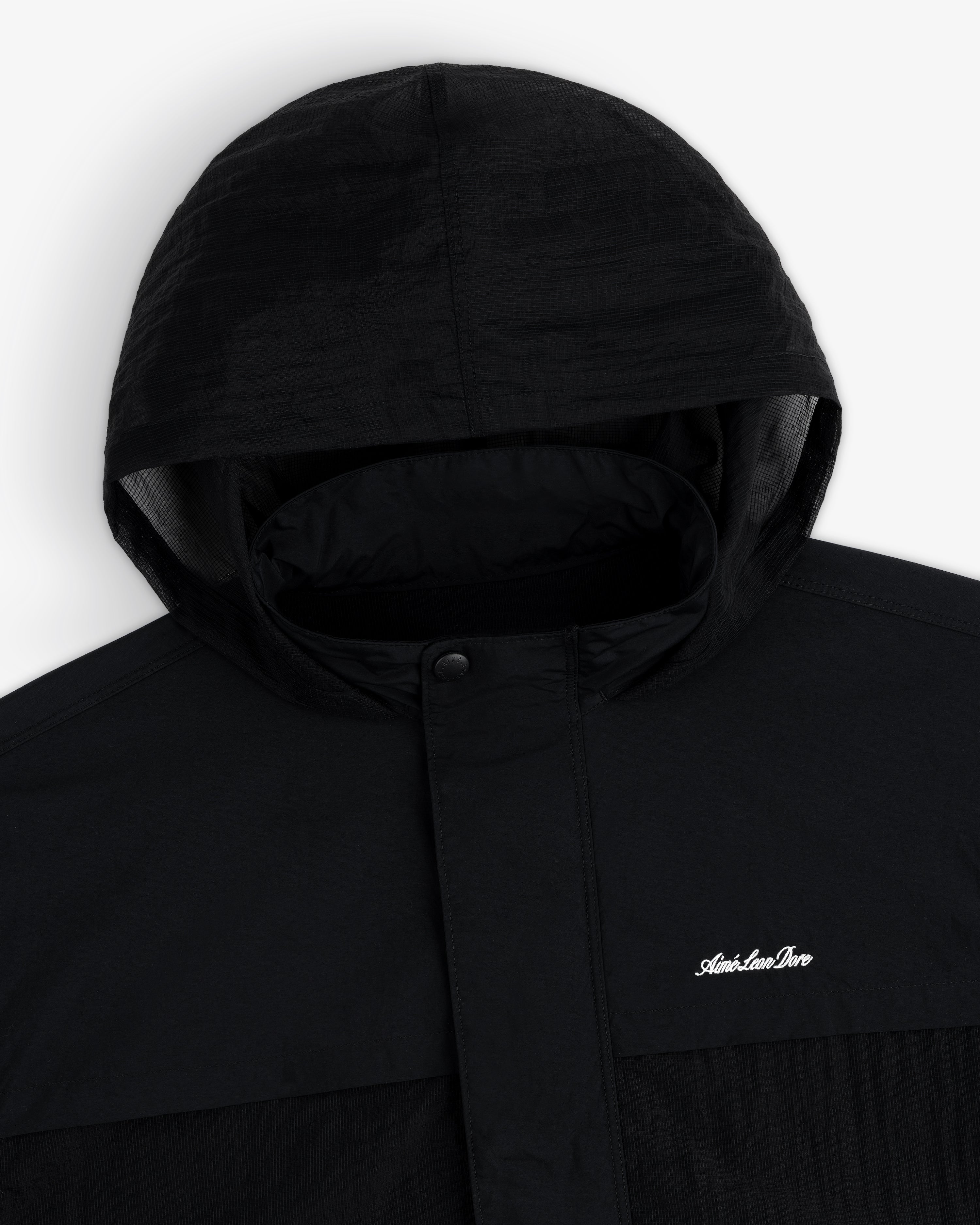 Black Nylon Track Jacket with snap button collar and small white "Adventure Pro" logo on the chest.