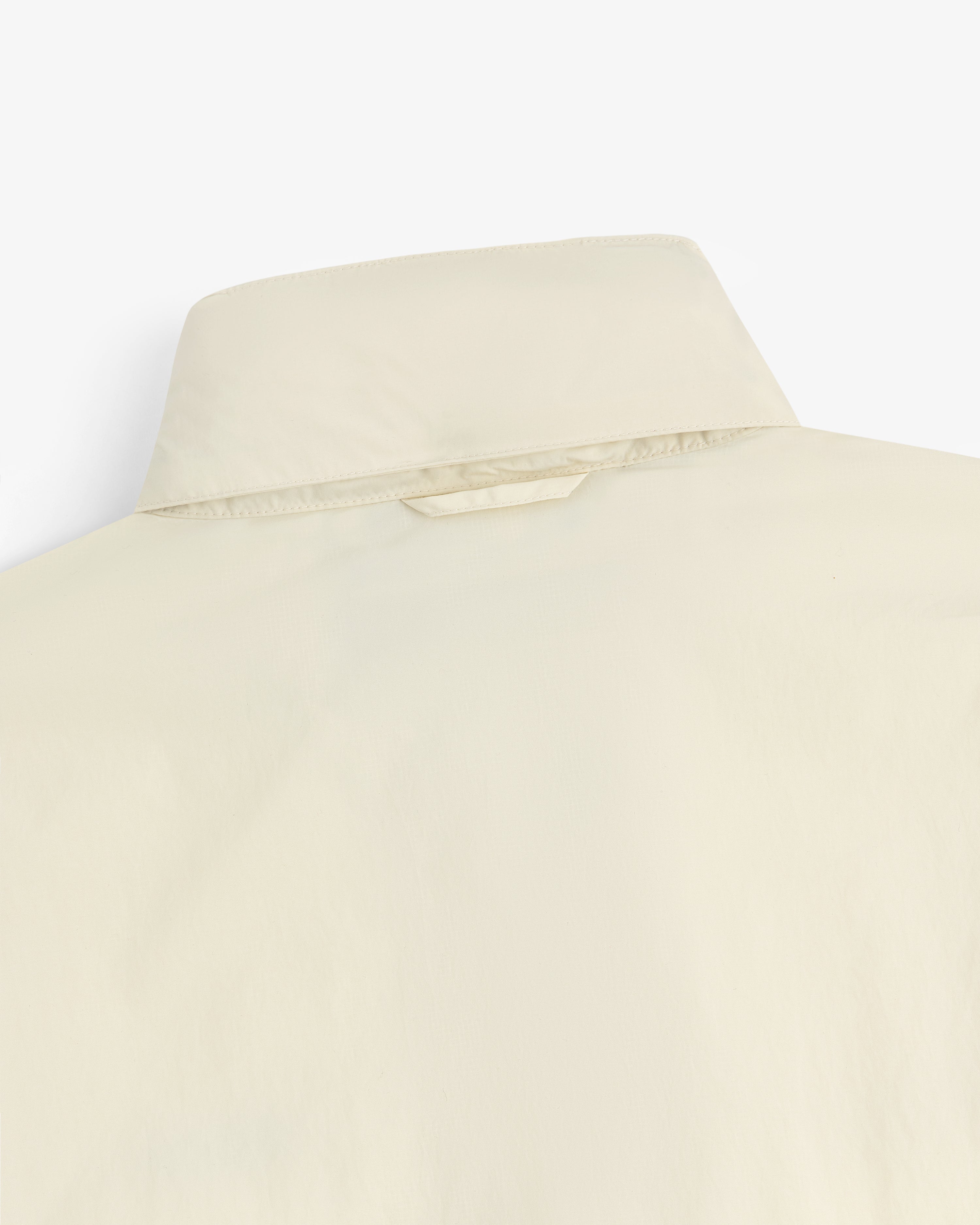 Close-up of the back of a Nylon Track Jacket, showing the collar and a small fabric loop below it.