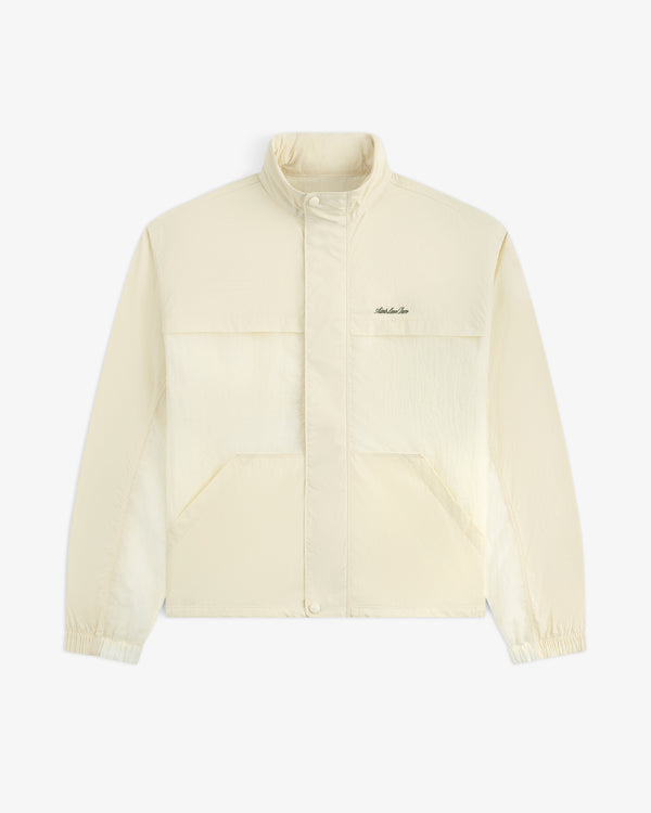 Light beige Nylon Track Jacket with long sleeves, snap buttons, front pockets, elastic cuffs, and left chest logo.