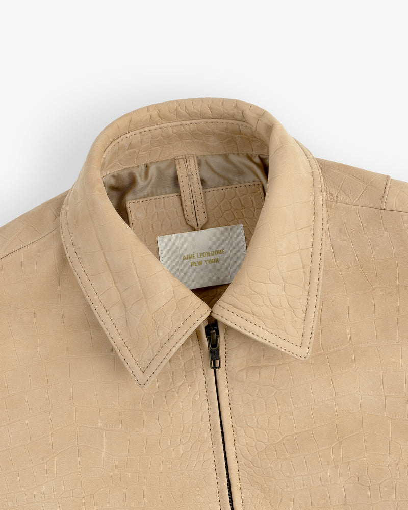 Close-up of a Croc-Embossed Nubuck Bomber Jacket with zipper and visible label inside the collar.