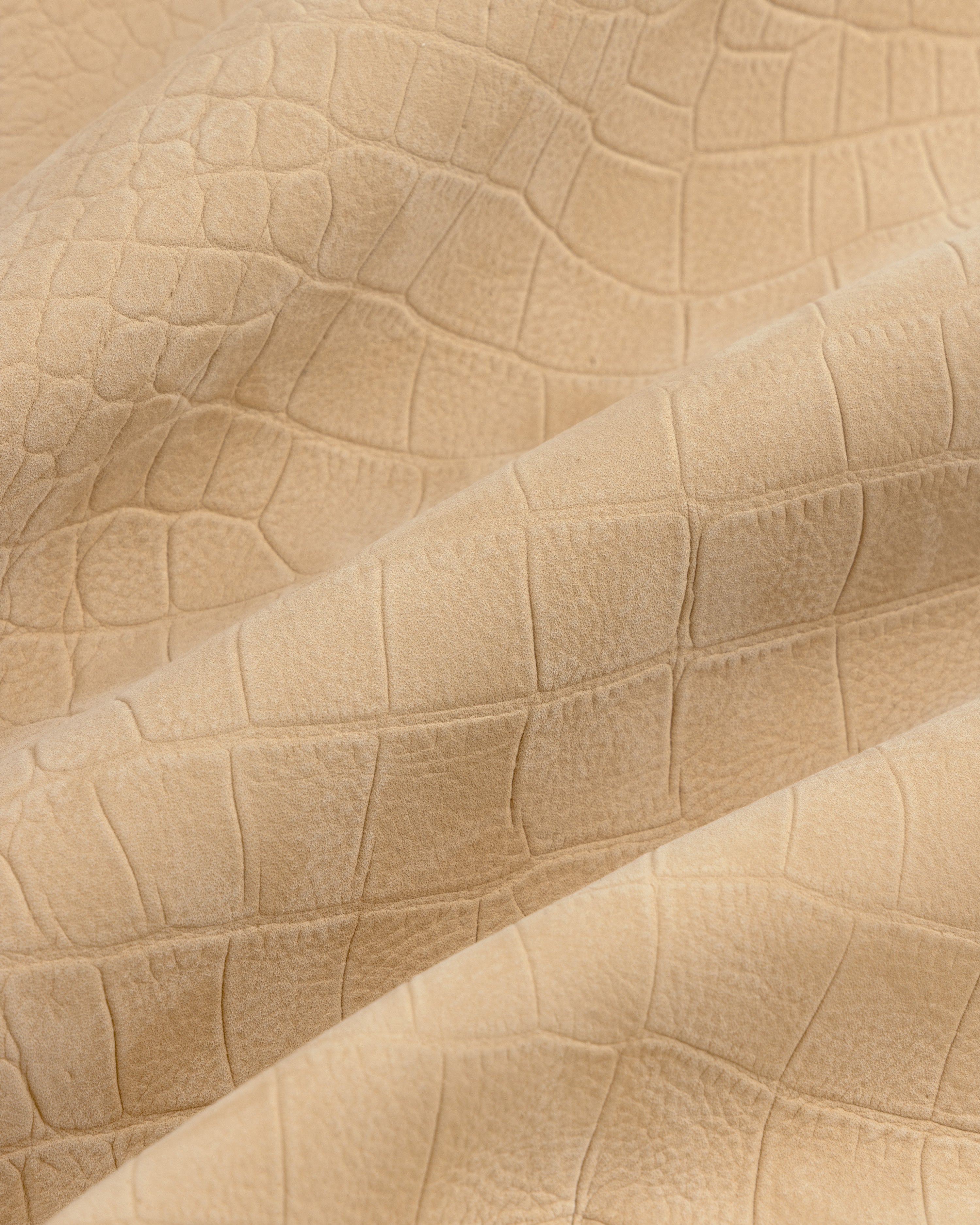 Croc-Embossed Nubuck Bomber Jacket in beige features a crocodile texture and subtle folds.