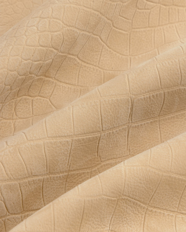 Croc-Embossed Nubuck Bomber Jacket in beige features a crocodile texture and subtle folds.