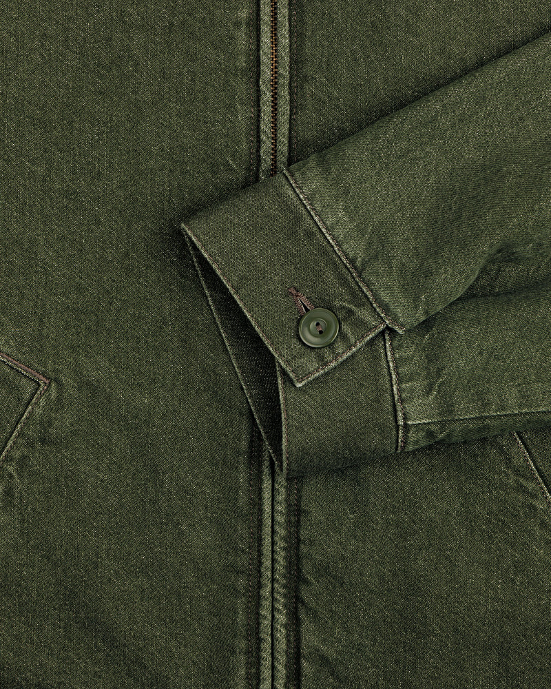 Close-up of a green Denim Zip Jacket sleeve with a buttoned cuff and visible stitching against the jacket’s body.