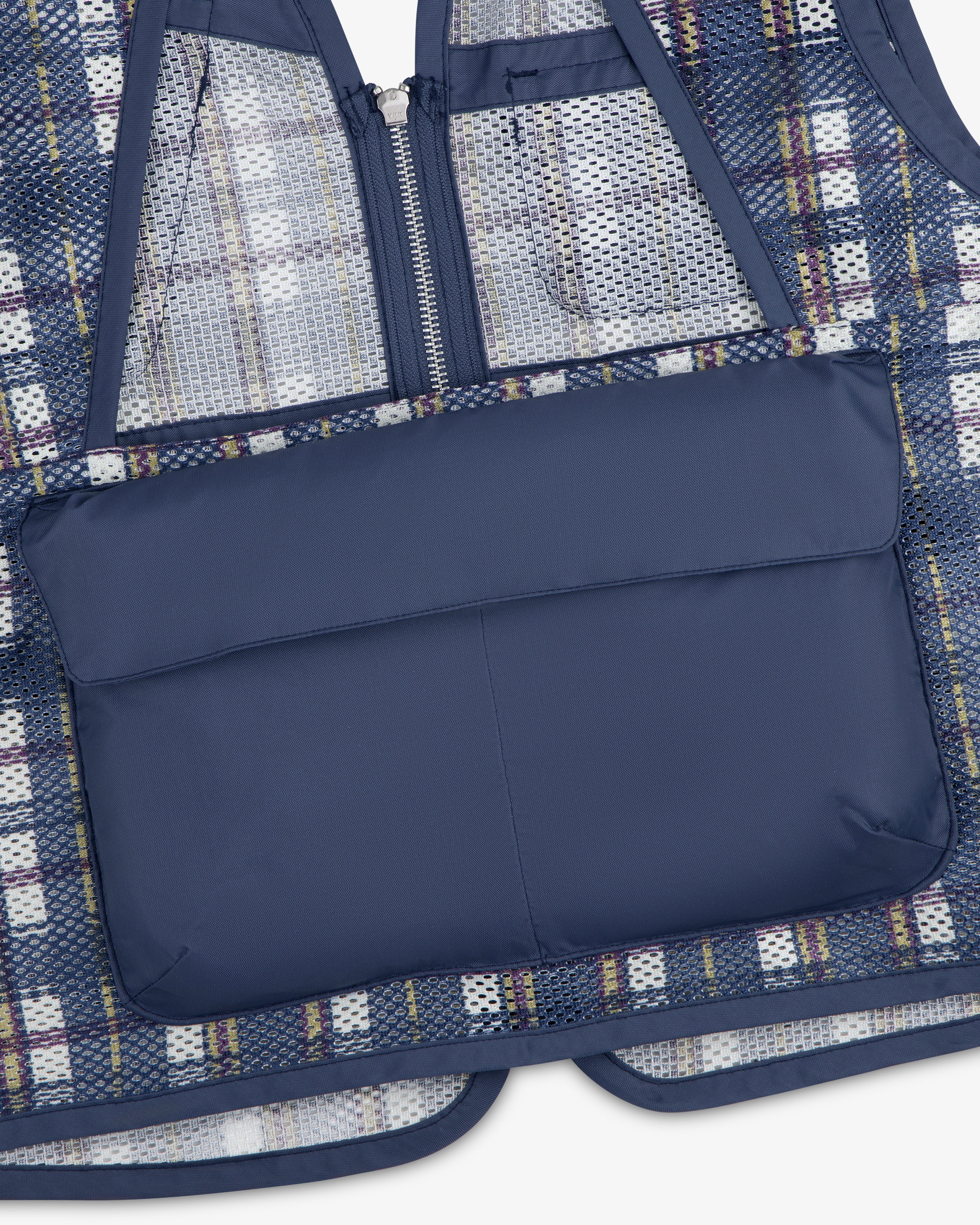 The Nylon Madras Utility Vest features a navy padded pocket, mesh and plaid fabric, a zipper, and blue trim.