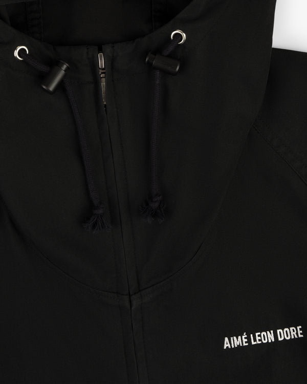 Close-up of the Micro Logo Lightweight Jacket, a black zip hoodie with AIMÉ LEON DORE embroidered in white on the chest.