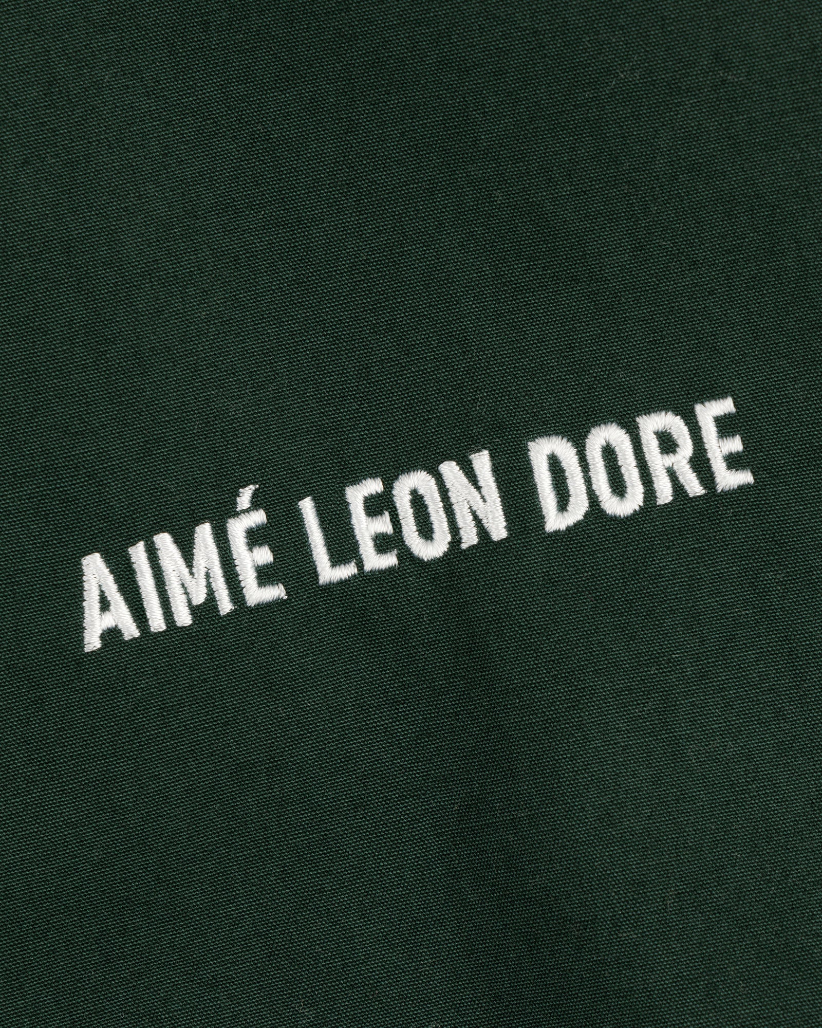 Green Micro Logo Lightweight Jacket with AIMÉ LEON DORE embroidered in white, all uppercase letters.