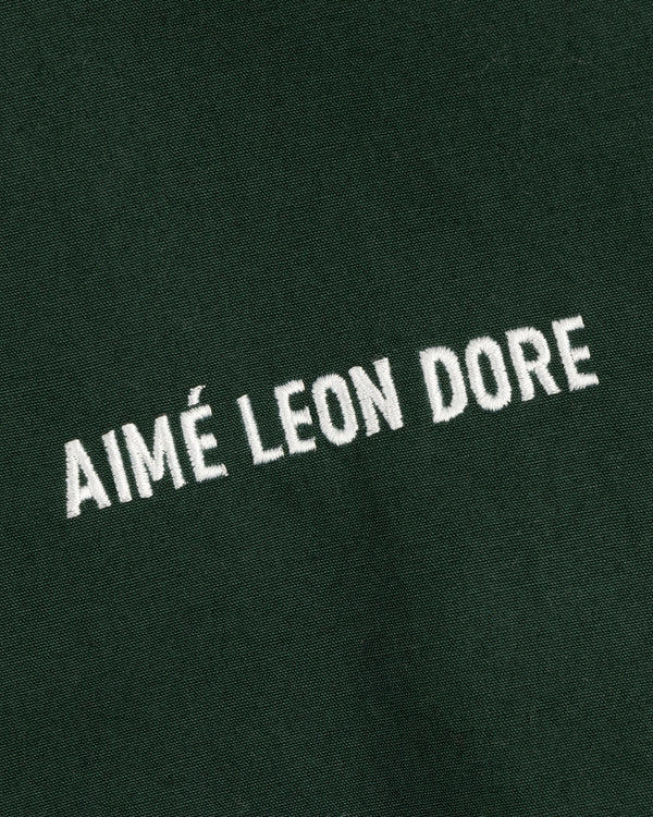 Green Micro Logo Lightweight Jacket with AIMÉ LEON DORE embroidered in white, all uppercase letters.