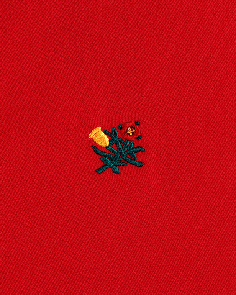 Small yellow and red embroidered flowers with green stems adorn the Crest Casual Jacket’s bright red fabric.