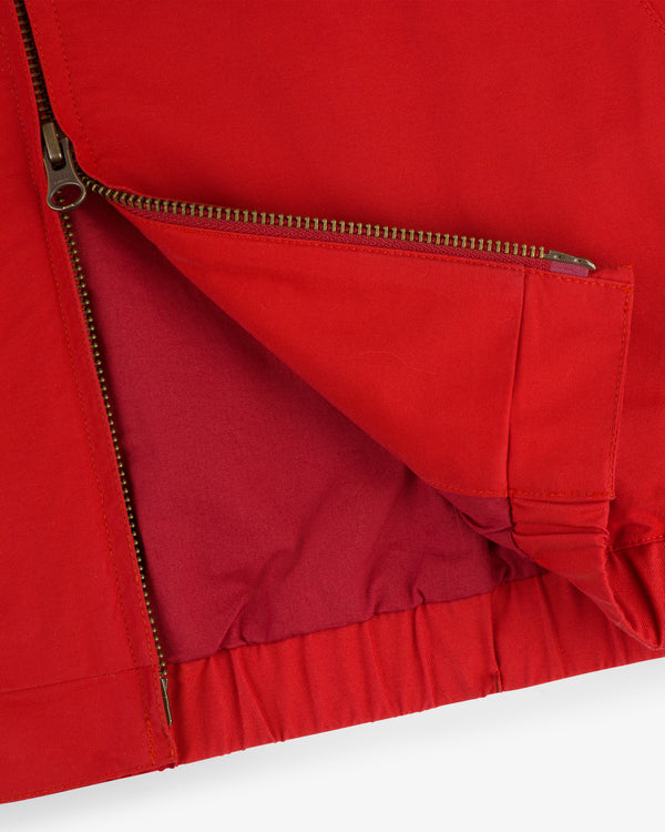 Close-up of the Crest Casual Jacket in red, showing a metal zipper and a partially opened side pocket.