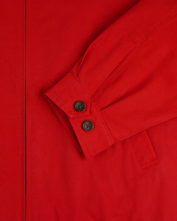 Close-up of the Crest Casual Jacket in red, featuring a long sleeve with two black cuff buttons and a visible seam.