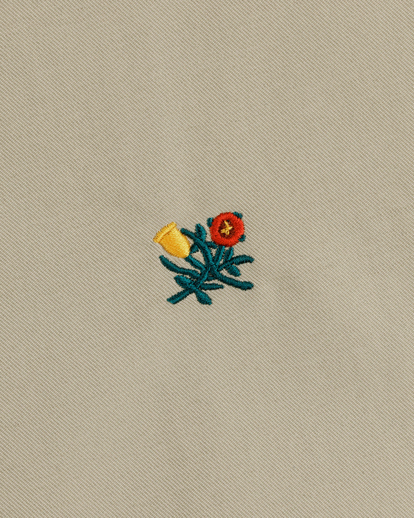 Crest Casual Jacket features embroidered yellow and red flowers with green stems on a beige fabric background.