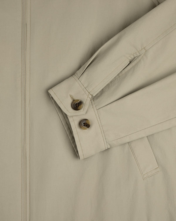 Close-up of the Crest Casual Jacket sleeve with two buttons and strap detail on a matching beige background.