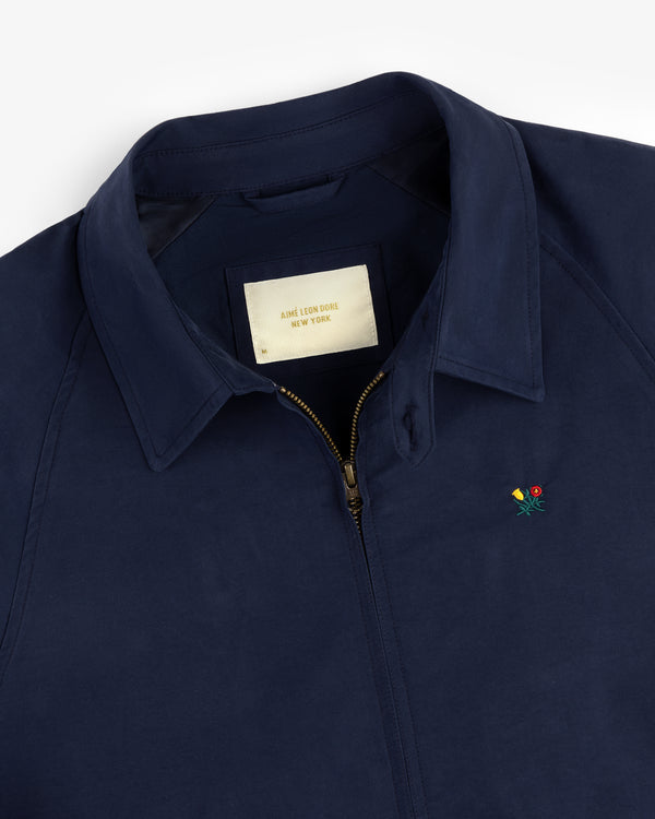 Navy Crest Casual Jacket with zip-up front, small embroidered flower, and Aime Leon Dore New York label.