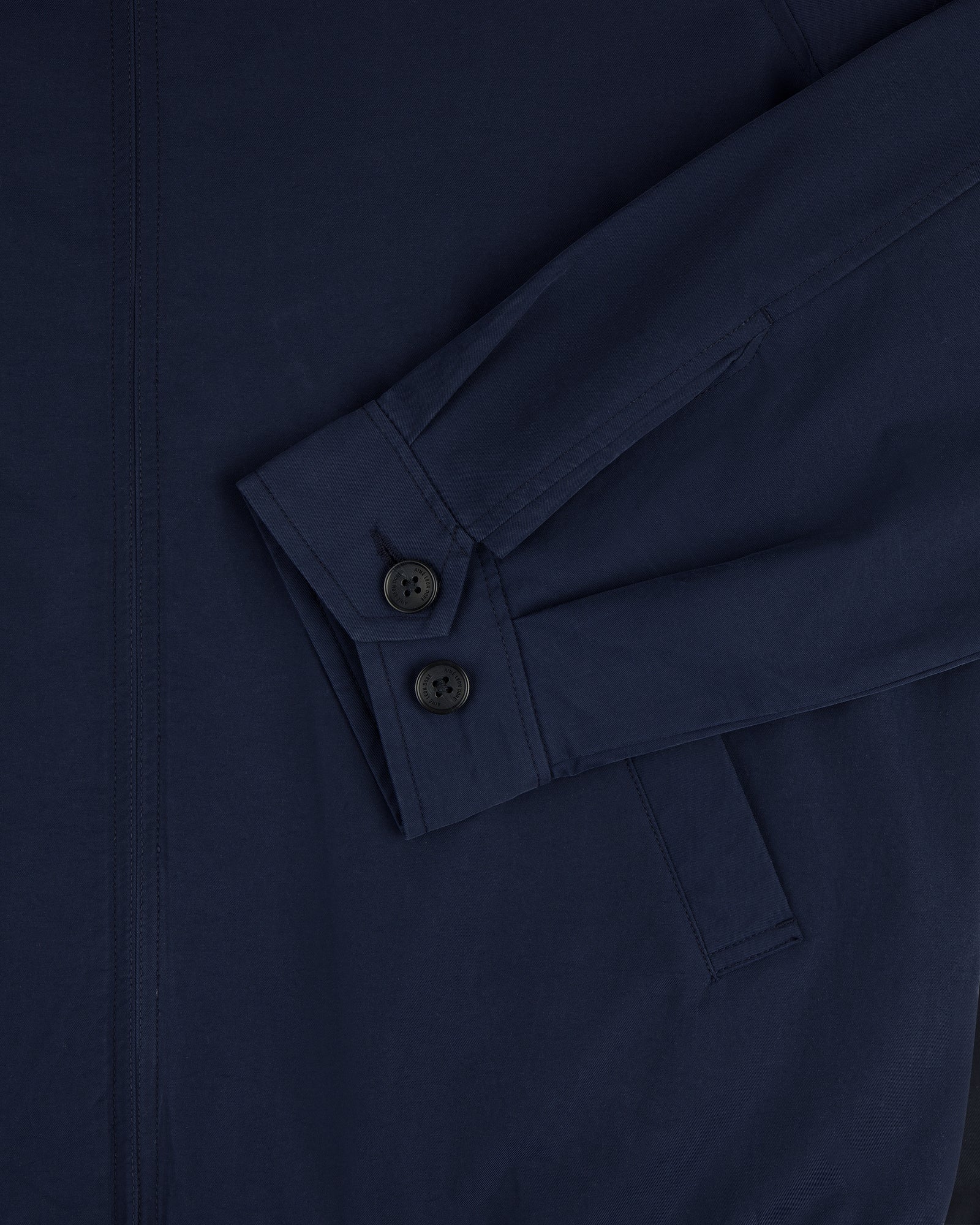 Close-up of Crest Casual Jacket in navy blue, showing sleeve with two black buttons and a visible pocket.