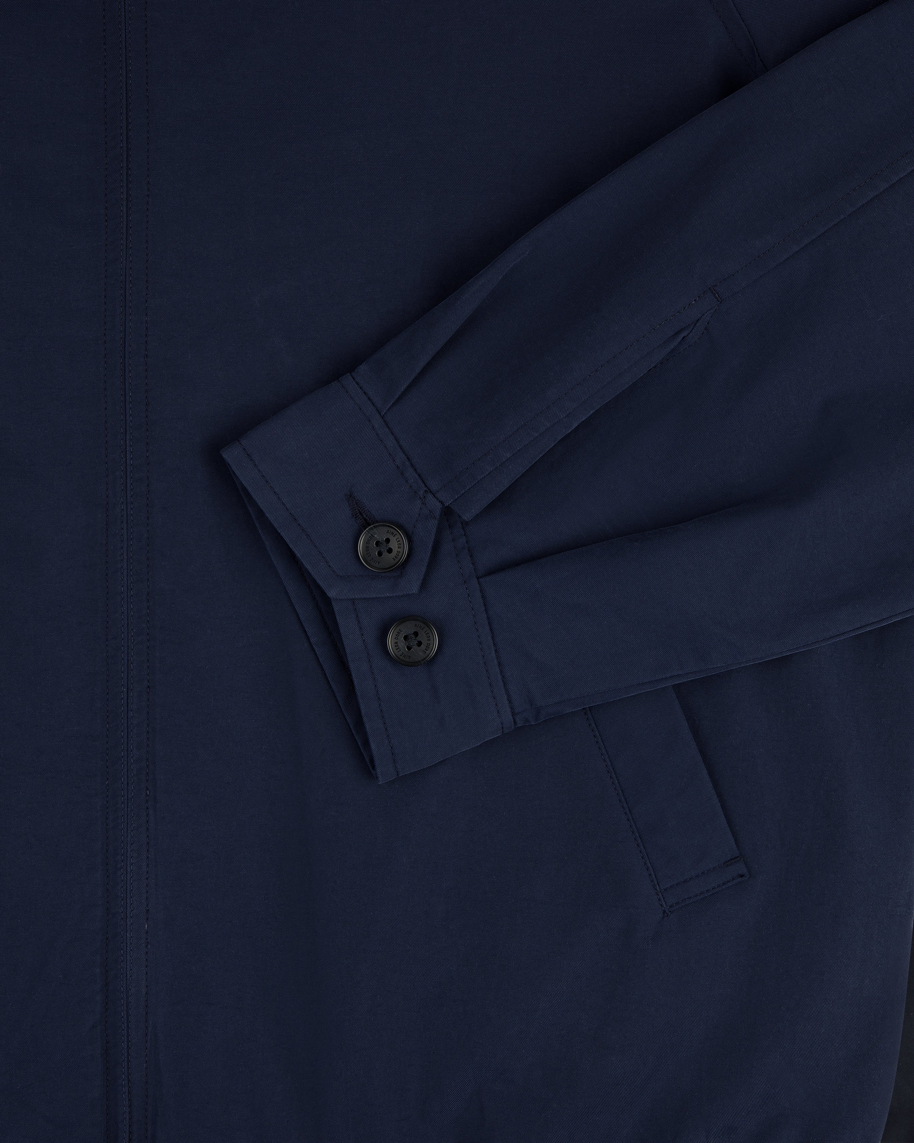 Close-up of Crest Casual Jacket in navy blue, showing sleeve with two black buttons and a visible pocket.