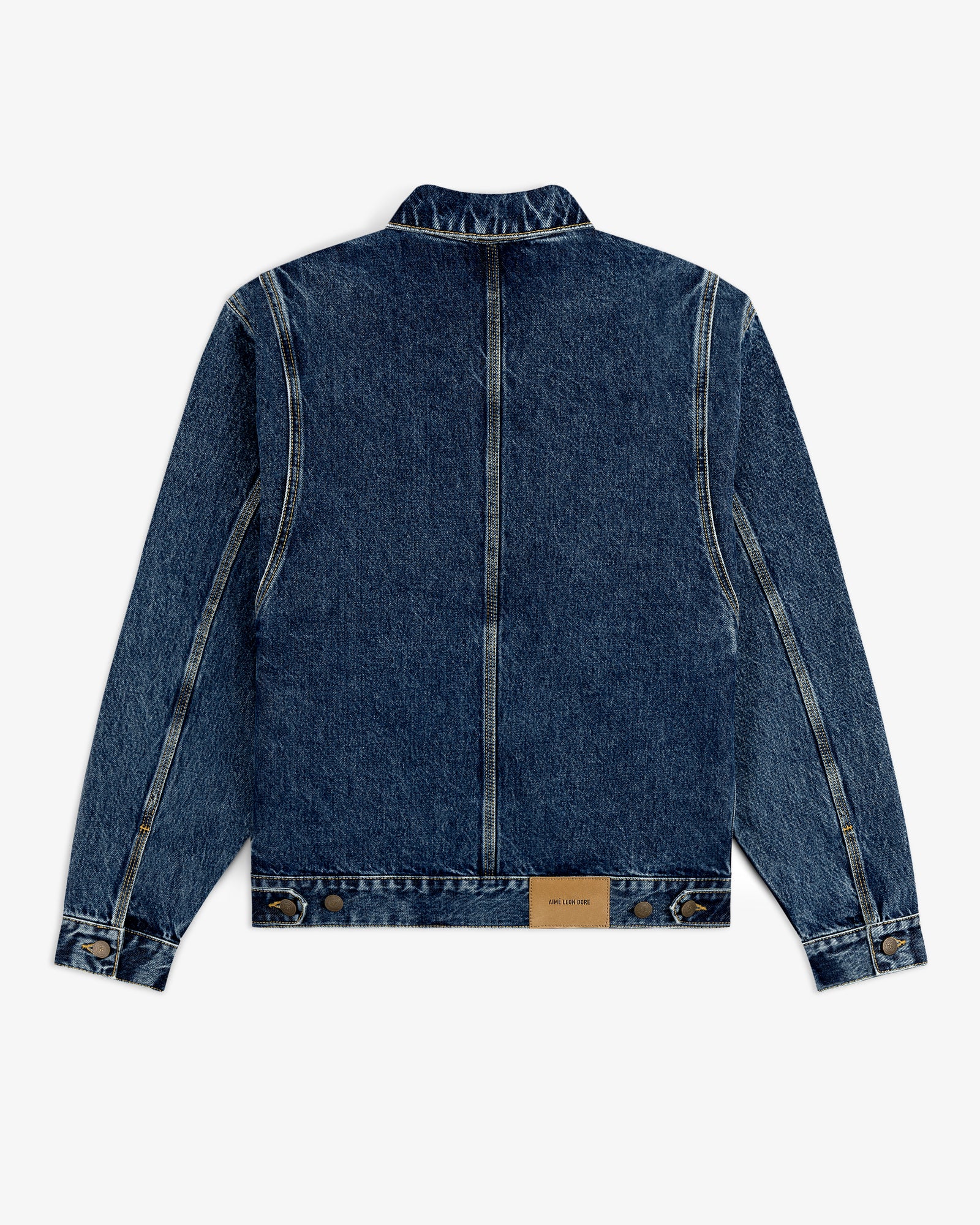 Back view of the Denim Trucker Jacket in blue with seam details and a brown leather patch near the hem.
