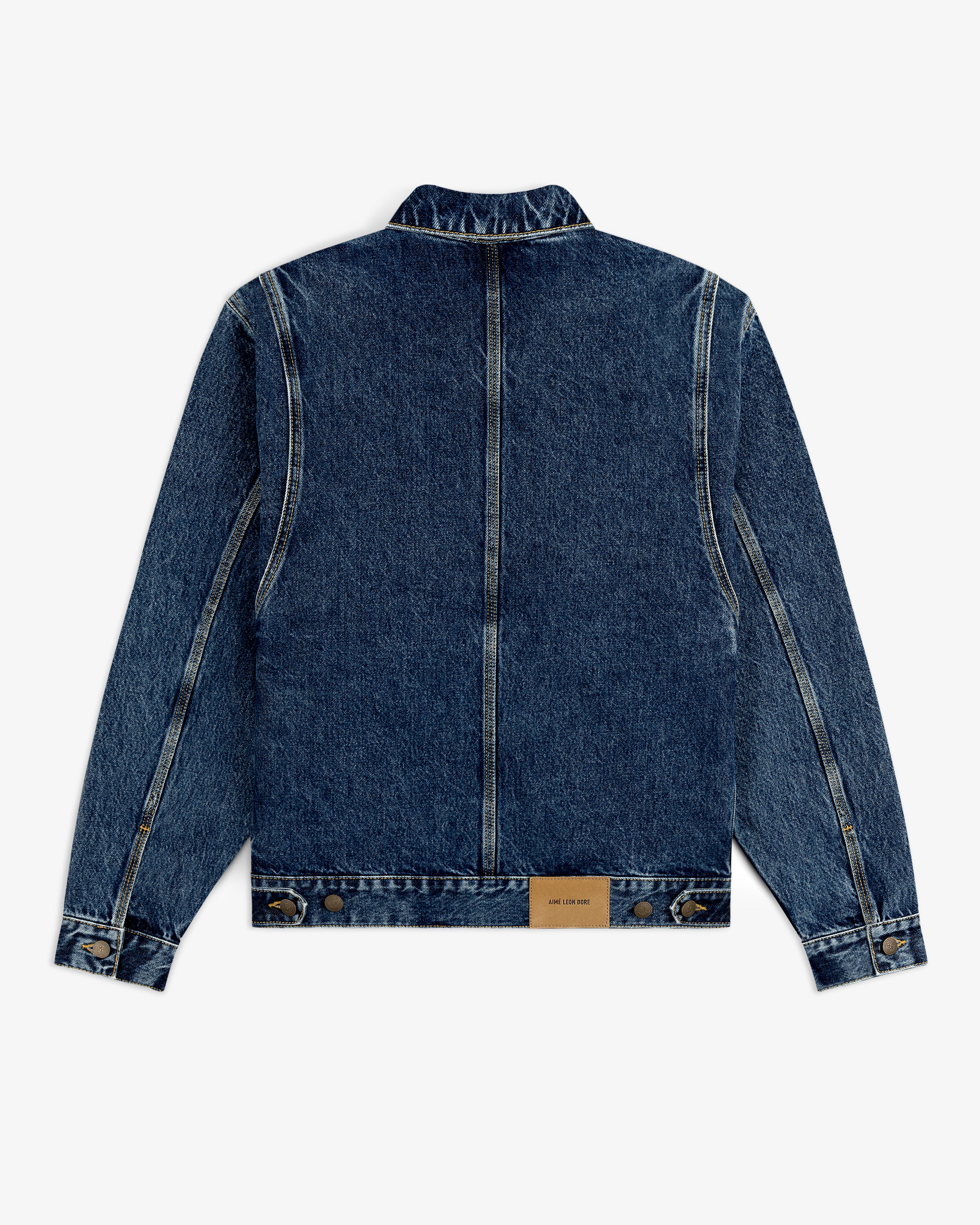 Back view of the Denim Trucker Jacket in blue with seam details and a brown leather patch near the hem.