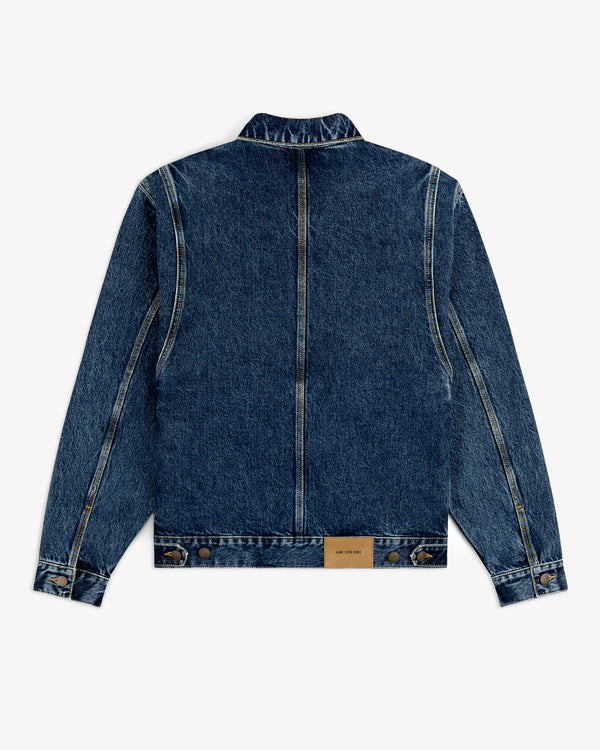 Back view of the Denim Trucker Jacket in blue with seam details and a brown leather patch near the hem.