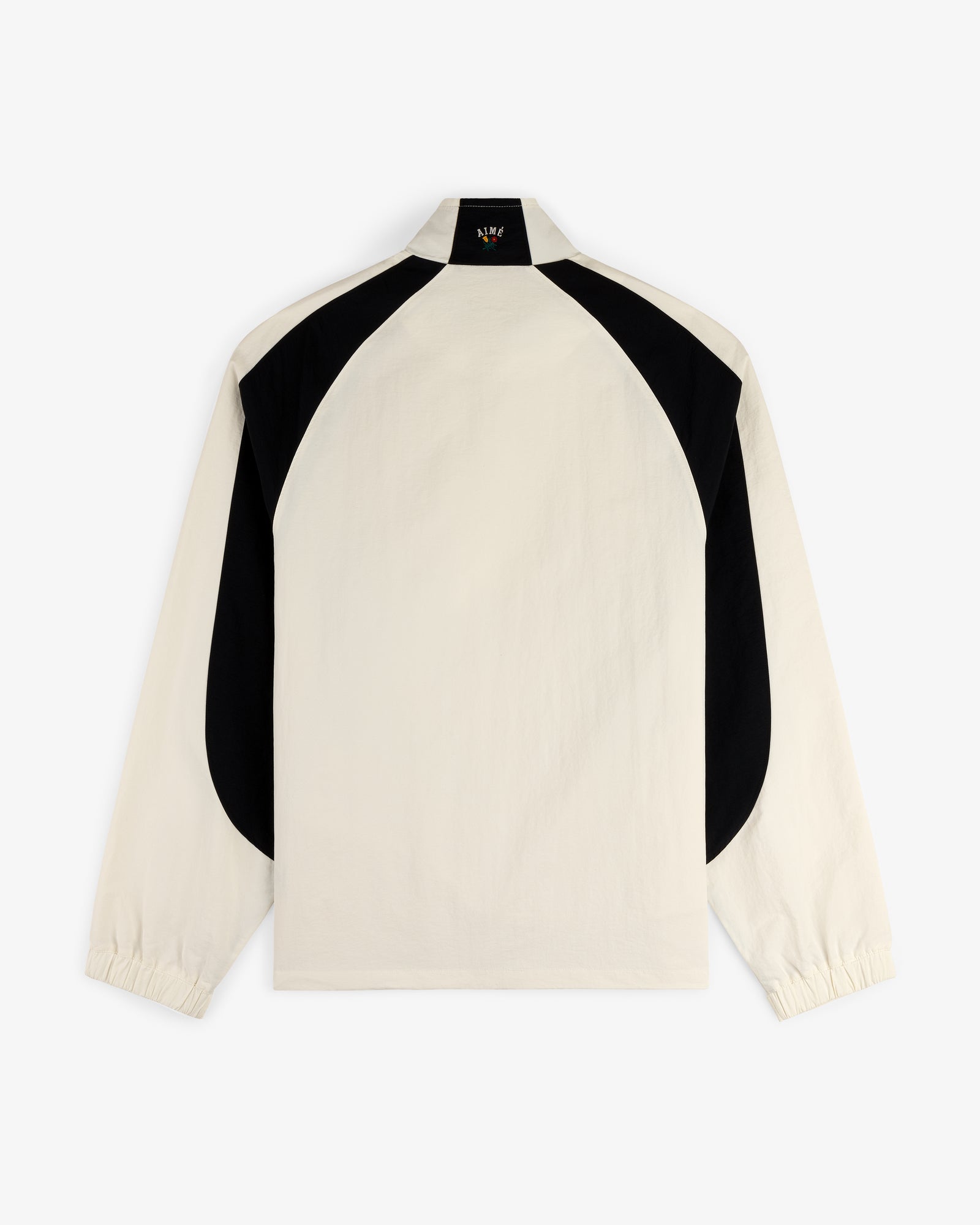 Crest Nylon Half-Zip Pullover in beige with black curved back panels and elastic cuffs, shown on white background.
