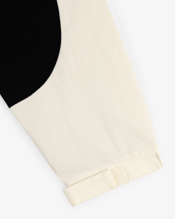 Close-up of the Crest Nylon Half-Zip Pullover’s cream sleeve with black curved detail and a turned-up cuff.