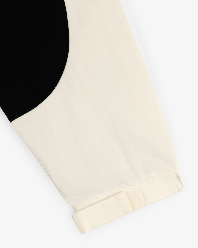 Close-up of the Crest Nylon Half-Zip Pullover’s cream sleeve with black curved detail and a turned-up cuff.