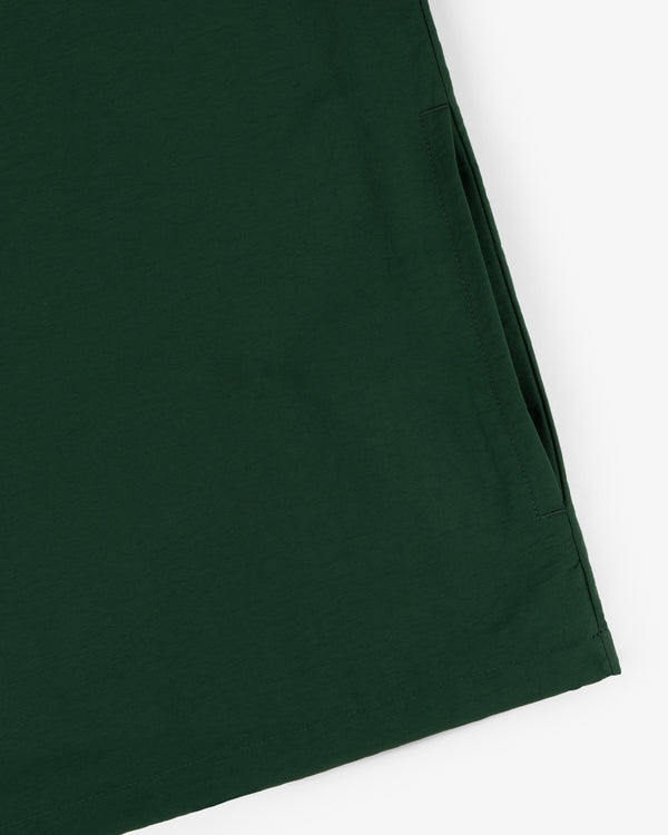 Close-up of the Crest Nylon Half-Zip Pullover in dark green, showing its neat edge and side pocket.