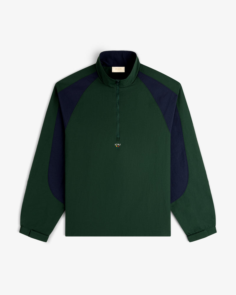 Dark green and navy Crest Nylon Half-Zip Pullover with long sleeves and a subtle chest logo.