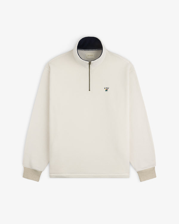 Crest Quarter-Zip Fleece Pullover in cream with beige cuffs, dark collar lining, and small left chest logo.