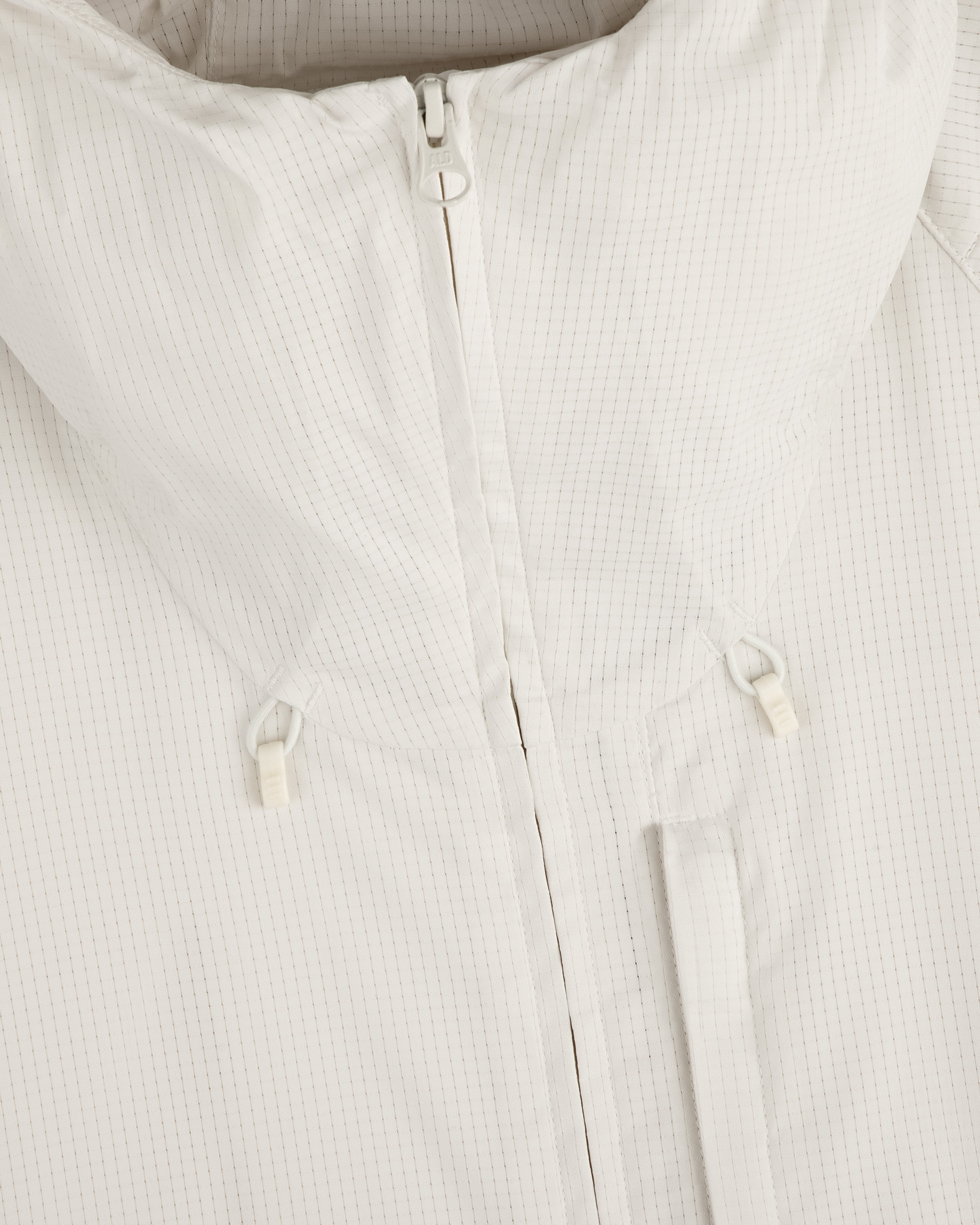 Close-up of the ALD Golf Lightweight Tips Windbreaker in white with high collar, front zipper, and drawstring toggles.