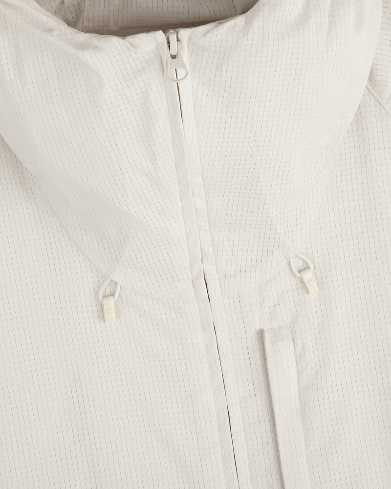 Close-up of the ALD Golf Lightweight Tips Windbreaker in white with high collar, front zipper, and drawstring toggles.