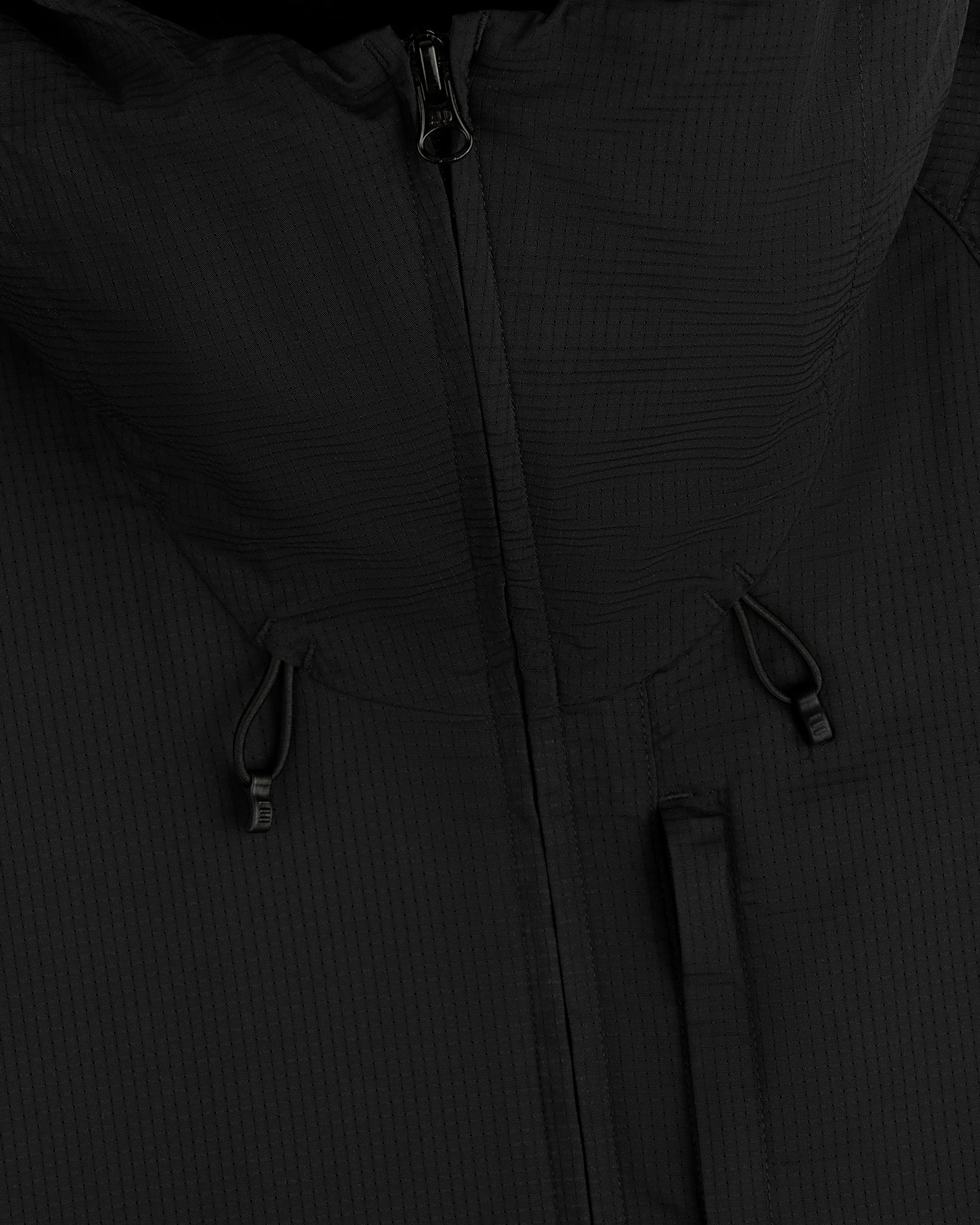 Close-up of the ALD Golf Lightweight Tips Windbreaker in black with hood, zipper, and drawstrings visible.